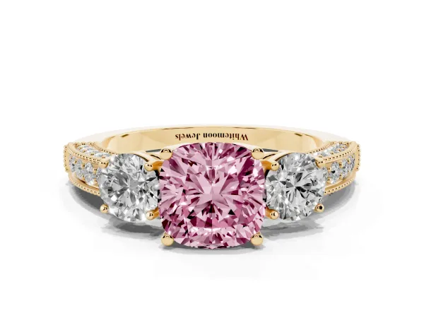 Fancy Pink Cushion Cut Three-Stone Diamond Ring with Pavé Band and Four-Prong Setting Yellow gold