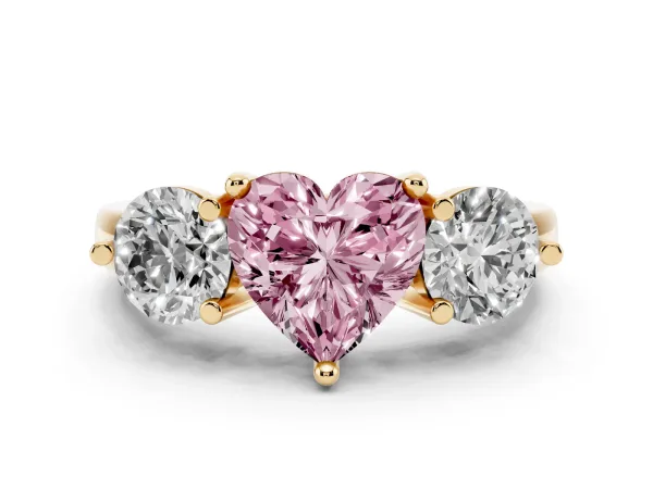 Fancy Pink Three-Stone Heart Cut Brilliant Cut Solitaire Ring with Prong Setting on a Classic Band Yellow gold