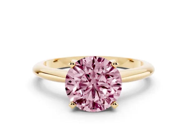 Fancy Pink Round Cut Cut Solitaire Ring with Four-Prong Setting on a Classic Band Yellow gold