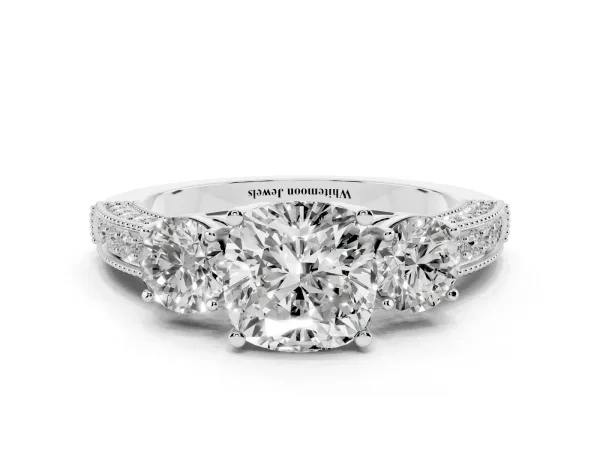 Cushion Cut Three-Stone Diamond Ring with Pavé Band and Four-Prong Setting Platinum