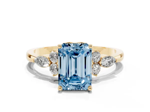 Fancy Blue Emerald Cut Brilliant Diamond Solitaire Ring with Pear Side Stones and Four-Prong Setting Yellow gold