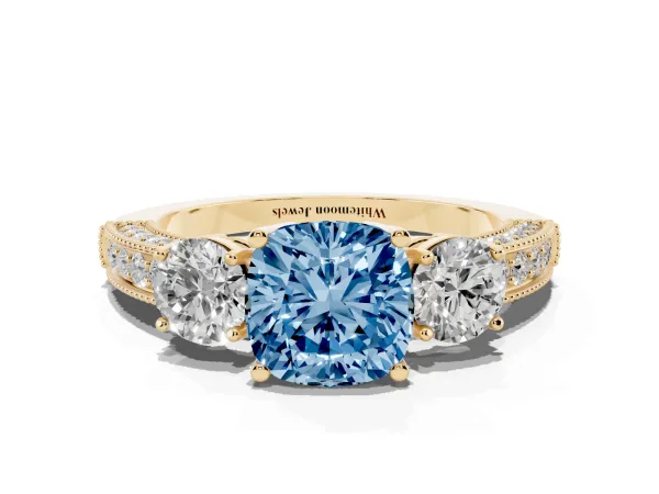 Fancy Blue Cushion Cut Three-Stone Diamond Ring with Pavé Band and Four-Prong Setting Yellow gold