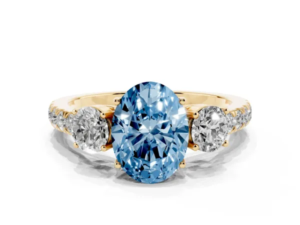 Fancy Blue Oval Cut Cut Diamond Three-Stone Ring with Round Side Stones and Pavé Band Yellow gold