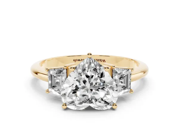 Heart Cut Diamond Three-Stone Ring with Trapezoid Side Stones and Prong Setting Yellow gold