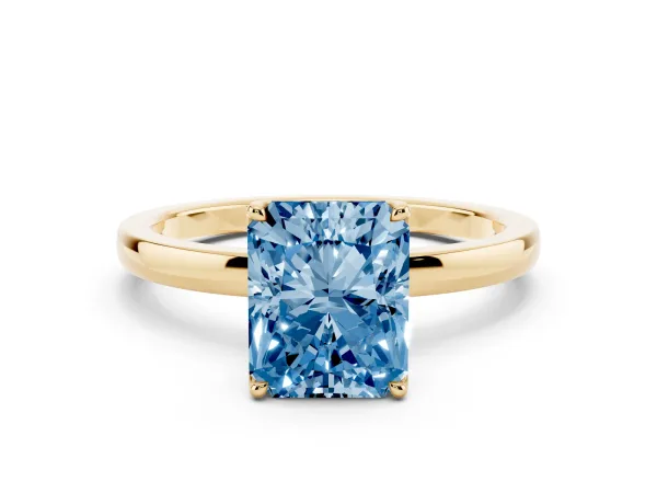 Fancy Blue Radiant Cut Diamond Solitaire Ring with Thin Band and Prong Setting Yellow gold