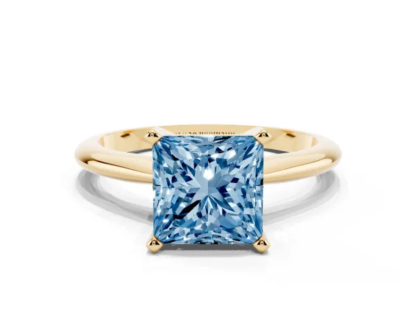 Fancy Blue Princess Cut Cut Solitaire Ring with Four-Prong Setting on a Classic Band Yellow gold