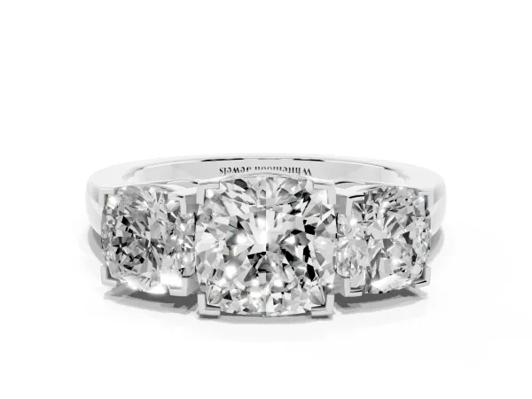Three-Stone Cushion Cut Cut Diamond Ring with Channel Set Band and Four-Prong Setting Platinum