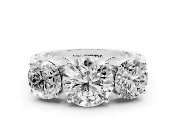 Round Cut Diamond Three-Stone Ring with Prong Setting and Textured Band Platinum