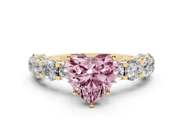 Fancy Pink Heart Cut Diamond Side Stone Engagement Ring with Four-Prong Setting Yellow gold