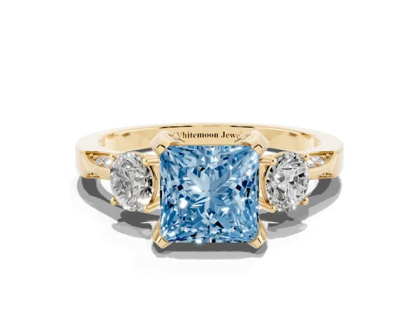 Fancy Blue Princess Cut Brilliant Three-Stone Diamond Ring with Pavé Band and Four-Prong Setting Yellow gold