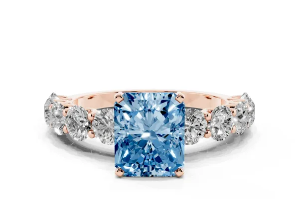 Fancy Blue Radiant Cut Diamond Prong Setting with Side Stones on a Pave Band Rose gold