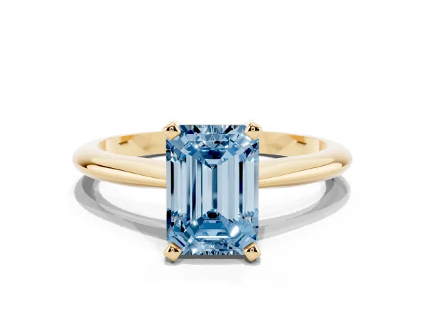 Fancy Blue Emerald Cut Cut Solitaire Ring with Four-Prong Setting on a Classic Band Yellow gold