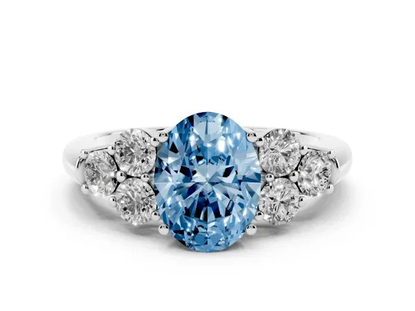 Fancy Blue Oval Cut Cut Diamond Cluster Ring with Round Accent Stones and Prong Setting on a Classic Band Platinum
