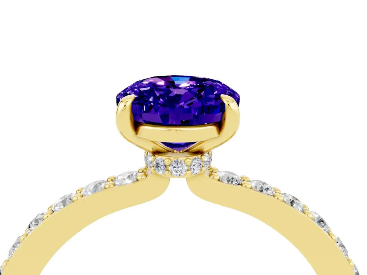 Oval Cut Tanzanite Solitaire Engagement Ring with Pavé Band and Four-Prong Setting Yellow gold