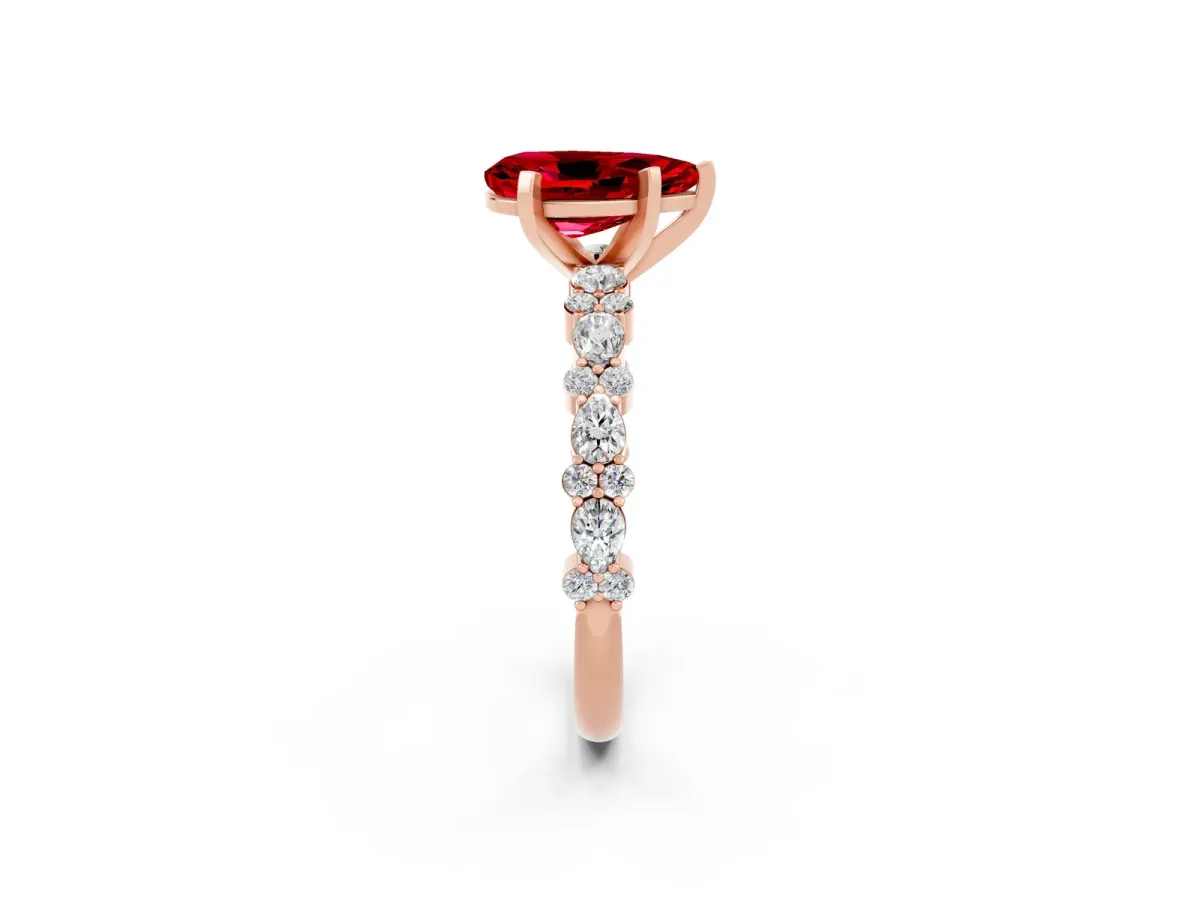Pear Cut Ruby Side Stone Solitaire Ring with Round and Four-Prong Setting Rose gold
