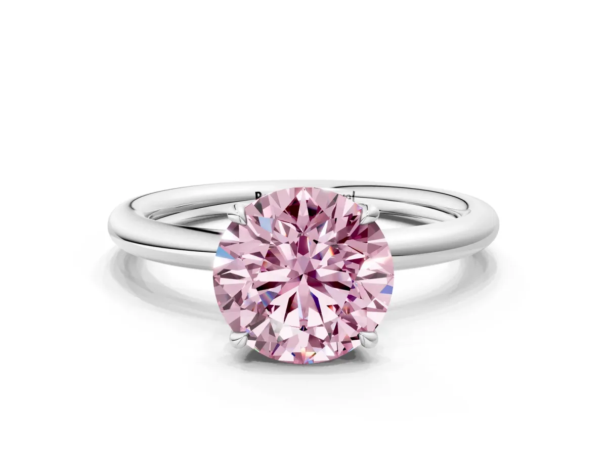 Fancy Pink Round Cut Diamond Solitaire Ring with Thin Band and Four-Prong Setting Silver