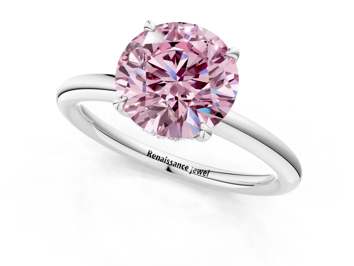 Fancy Pink Round Cut Diamond Solitaire Ring with Thin Band and Four-Prong Setting Silver