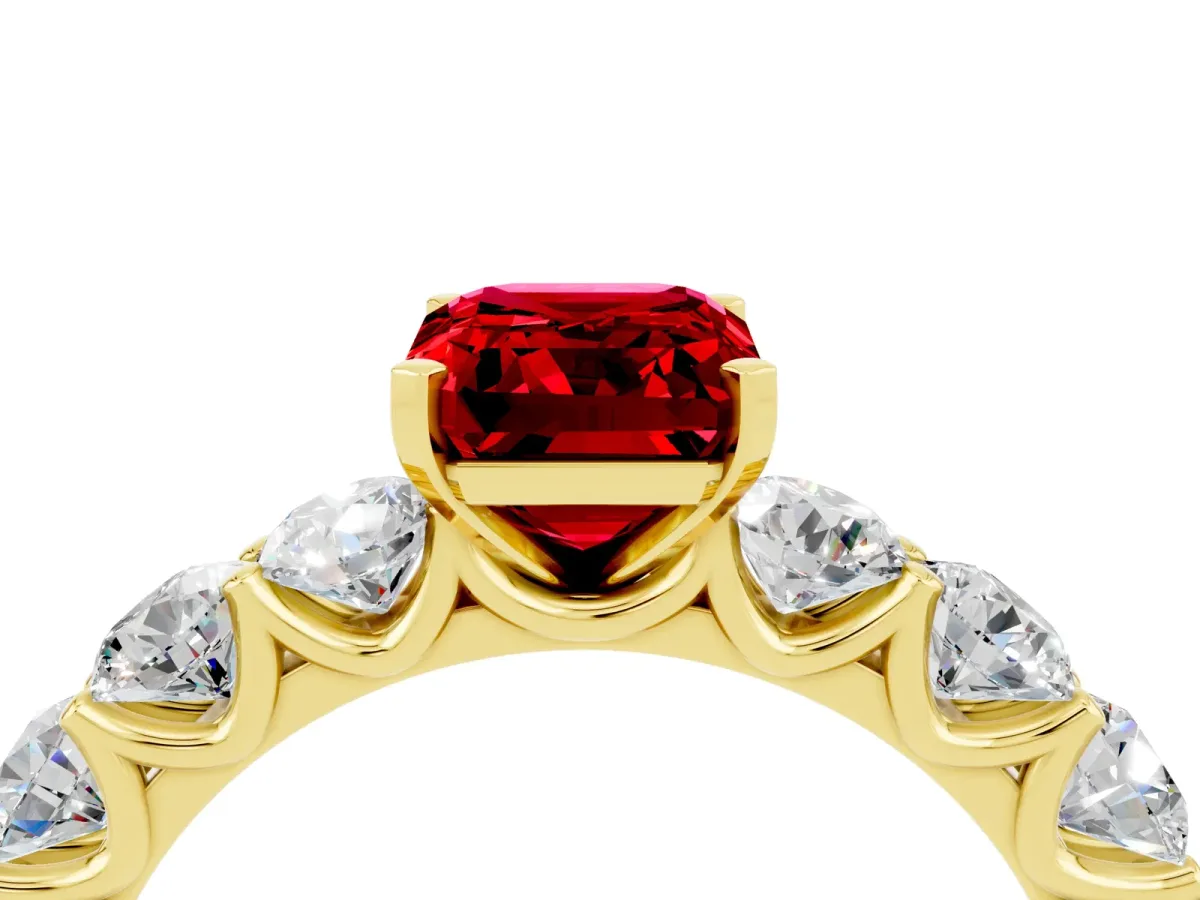 Emerald Cut Ruby Prong Setting with Side Stones on a Pave Band Yellow gold